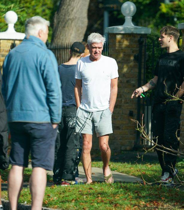 0_Phillip-Schofield-surveys-the-damage-a-fallen-tree-has-done-to-his-neighbours-house.jpg
