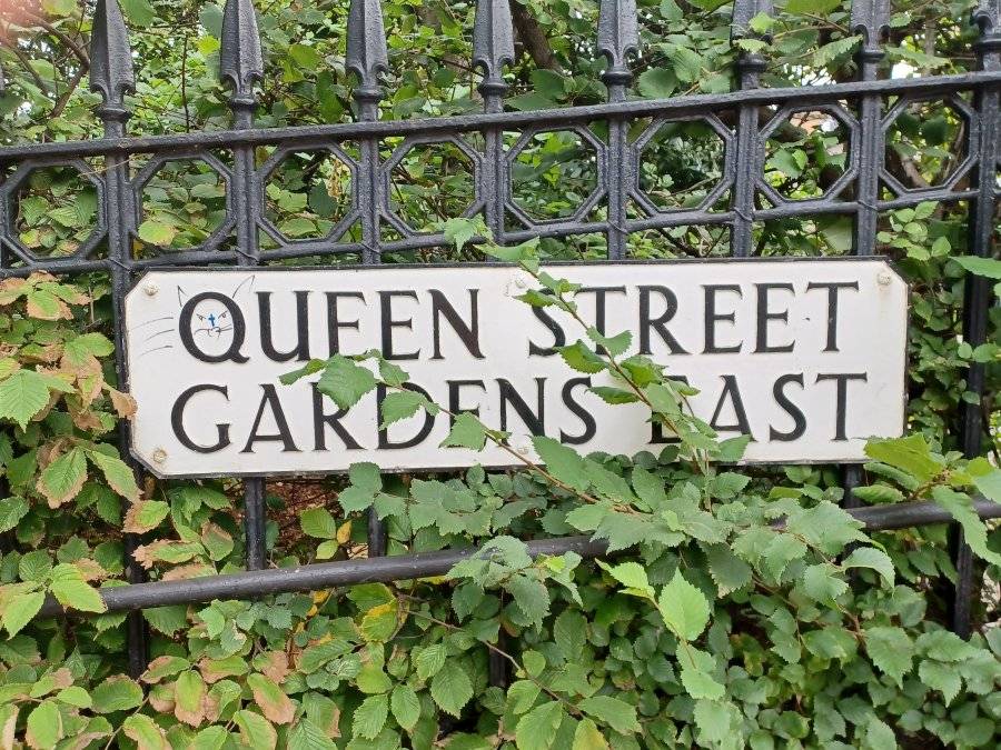 Queen Street Gardens sign where the Q is a cat