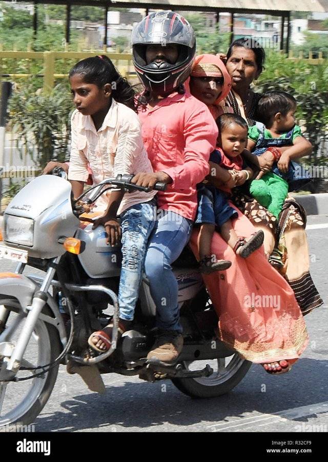 a-family-of-six-people-including-two-children-on-a-crowded-motorbike-on-the-highway-between-de...jpg