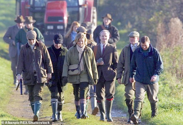 The Duke of York is pictured (far right) on the same pheasant shoot as Epstein and his former partner on the Queen's estate in December 2000